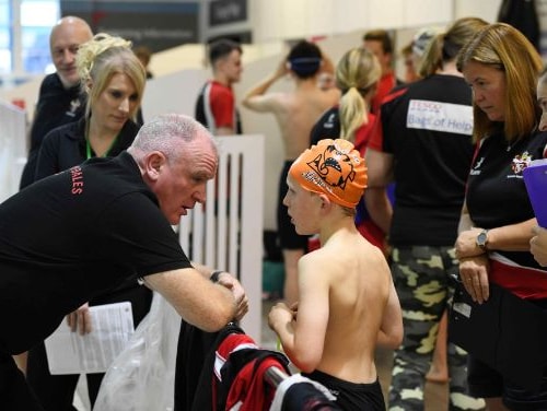Coach chatting with squad member