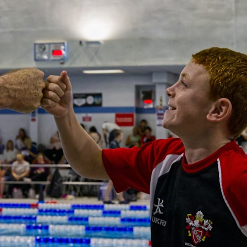 Swimming coach with team